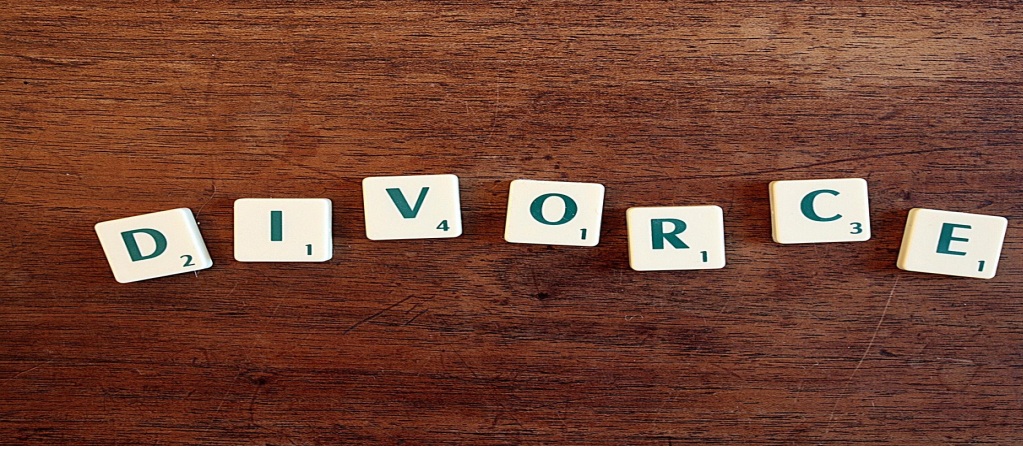 Game tiles with letters and numbers arranged to spell out “DIVORCE.”