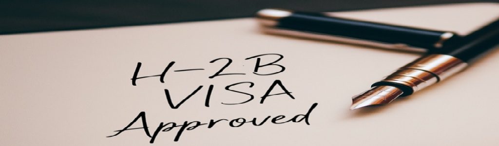A fountain pen resting on a document labeled "H-2B Visa Approved"